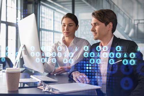 Two Agents Looking at their Computer with floating digital screen