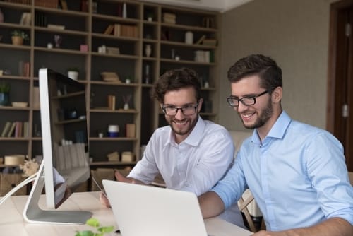 Two twin men working on their computers