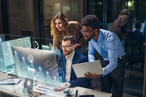 Real Estate Team looking at computer screen with futuristic pop-up screens